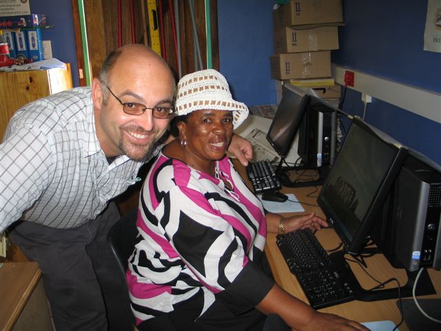 Andre and Mrs Olifant, principal of Kama Primary, in front of one of the 20 donated DELL computers