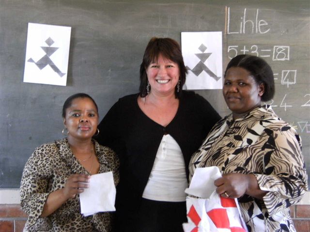 Pam Spady, facilitator, with two educators on the workshop